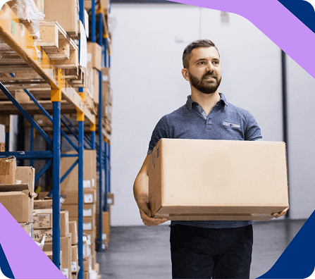 Warehouse team member carrying a packed ecommerce order